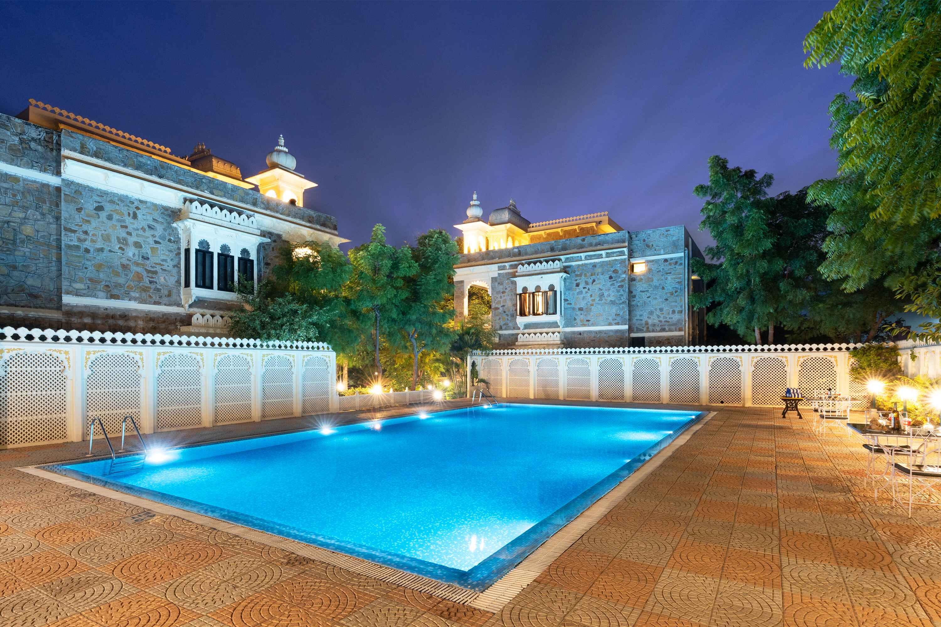 Heritage luxury hotel illuminated beautifully at night.