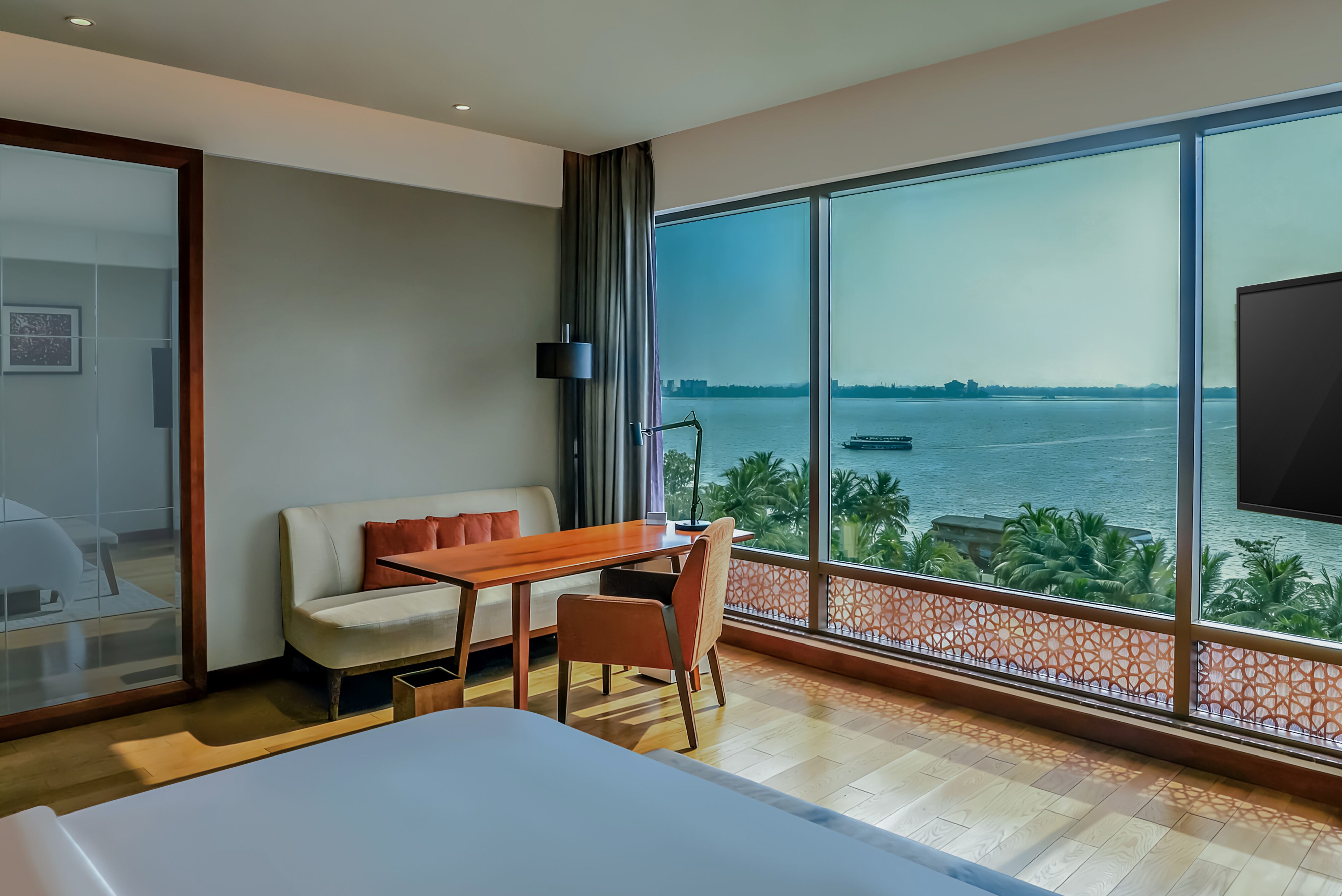 Premium hotel room interior with panoramic ocean view.