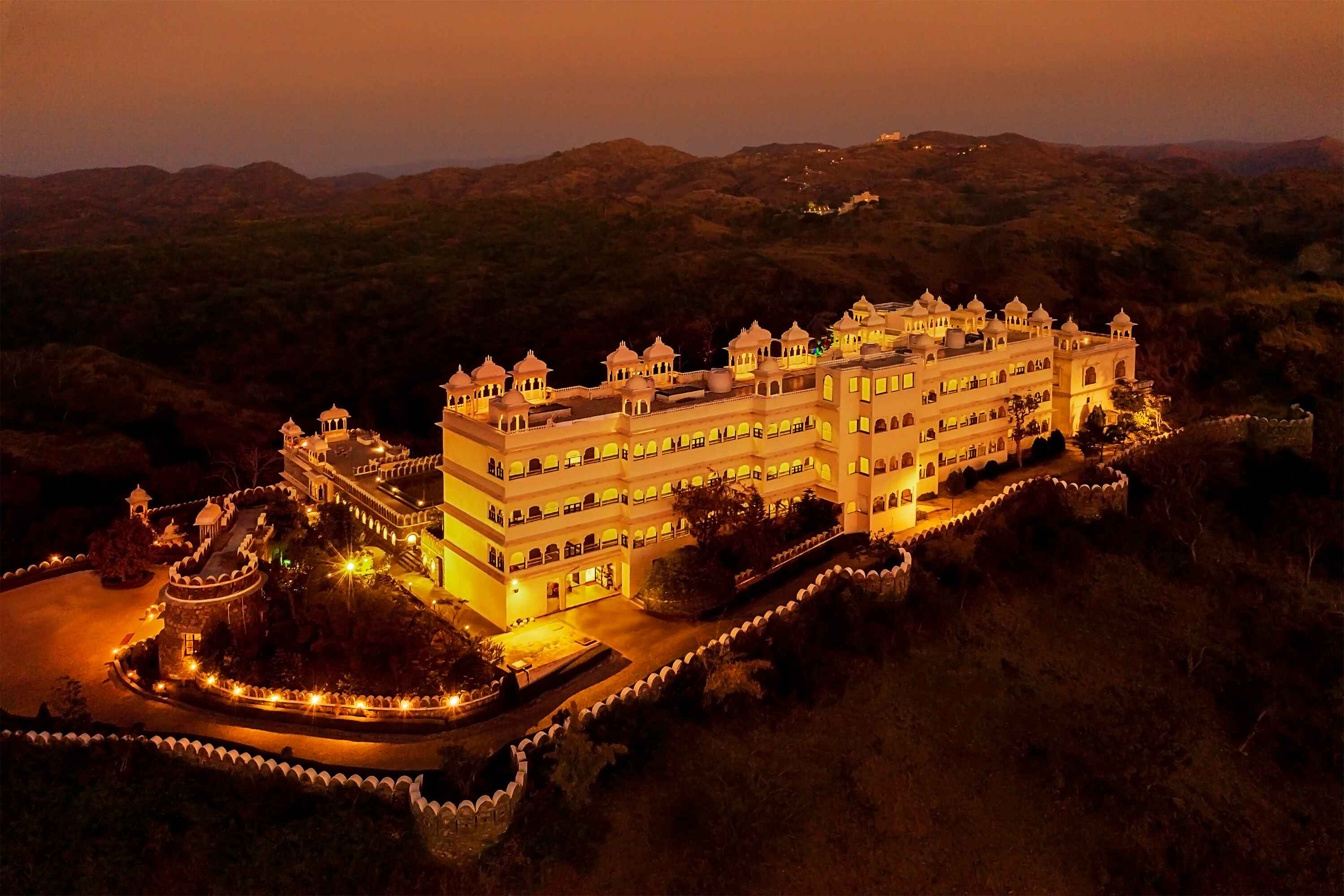 Aerial photograph of a grand luxury palace hotel surrounded by nature.