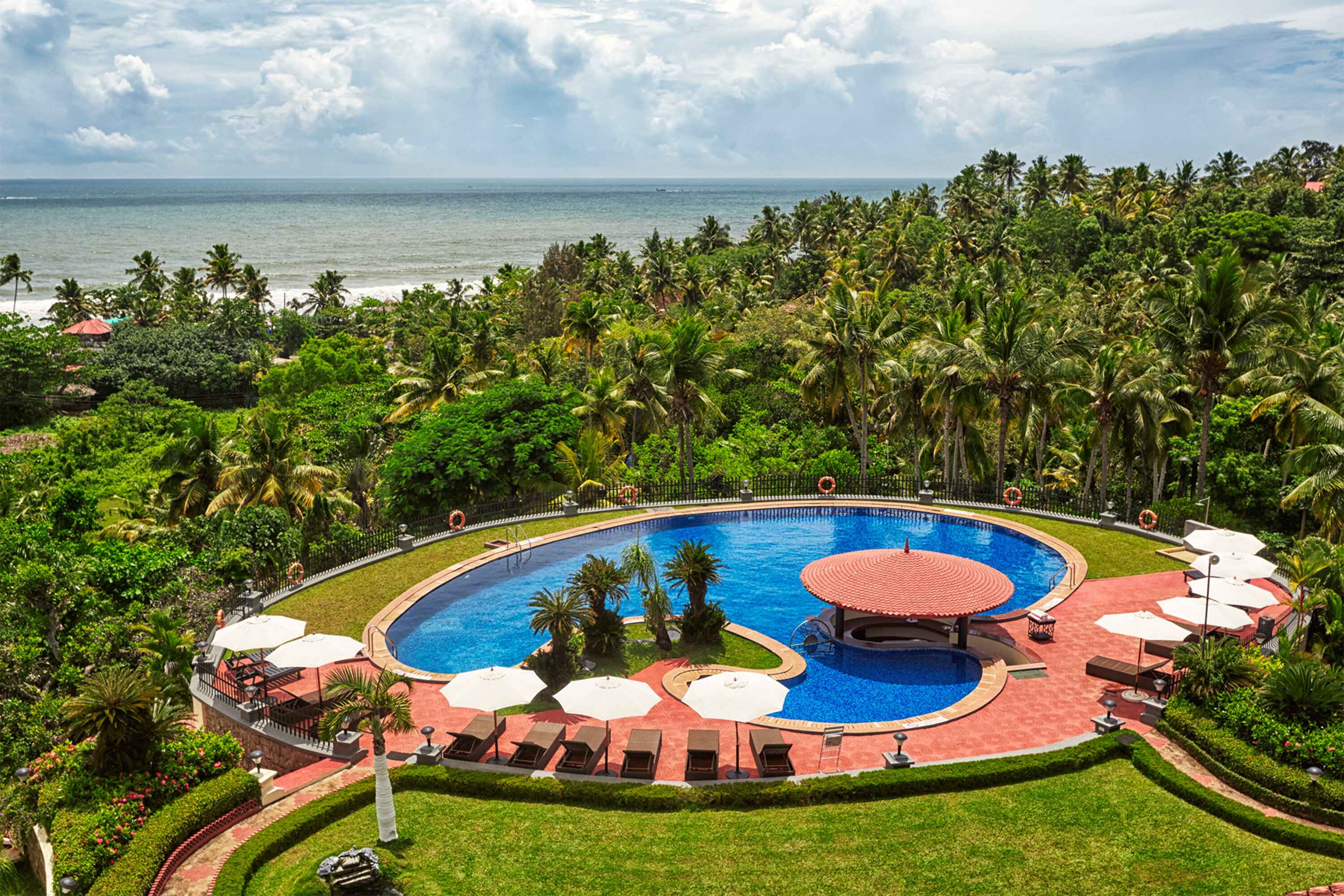 Drone view of a luxury beachfront resort highlighting architecture and landscape.